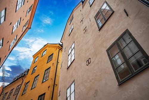 Colorful historical buildings under a blue sky in the Old Town of Stockholm, Sweden.
