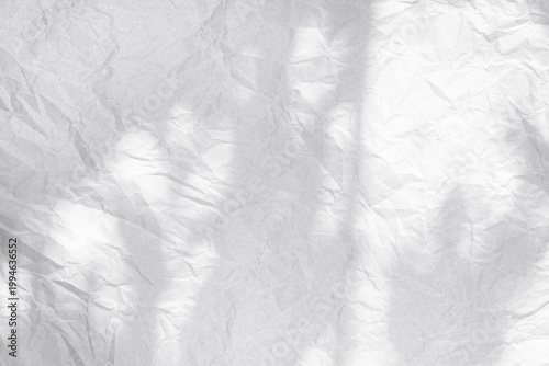 Light crumpled paper texture with natural folds and soft shadows. Abstract minimal background with wrinkled surface, ideal for design, overlays, branding and creative layouts