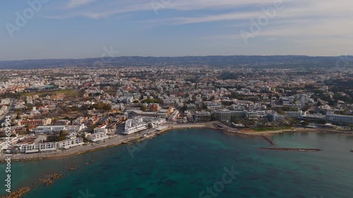 Aerial Orbit of Paphos Coastline Showing Modern Boardwalk and Historic Lighthouse in Cyprus