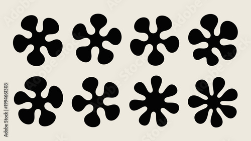 A minimalist composition showcases eight black abstract floral like shapes against a pale beige background creating a simple and modern design high quality professional detailed elegant