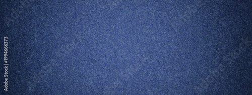 Dark blue suede fabric background with matte microfiber texture, soft navy felt surface with vignette in macro