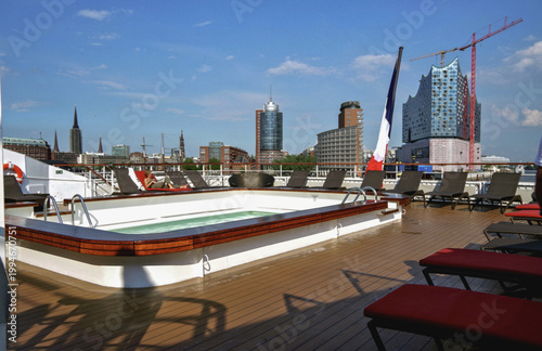 Deck chairs or sun loungers with table on balcony terrace patio promenade boat pool sun deck of luxury cruise ship cruiseship yacht liner with amazing oceanview