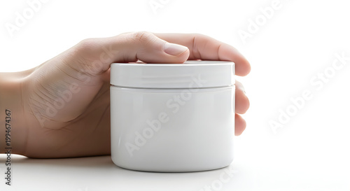 Hand holding a white cylindrical container with pink stripe