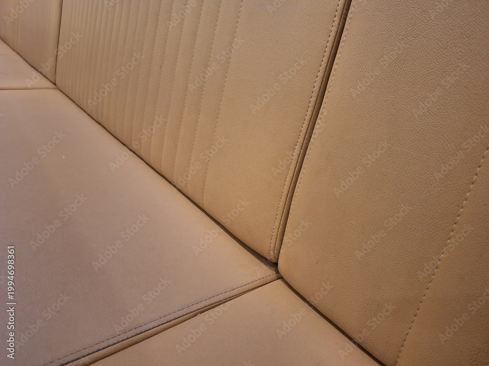 Fototapeta premium Close-up texture of beige tufted leather car seat