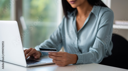 Professional woman using laptop and credit card for online purchase at office desk, digital finance and ecommerce concept, modern business payment routine, secure transaction, corp