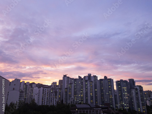 
It is a pink sunset and an apartment landscape.