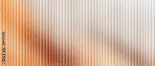 Corrugated glass texture with warm orange light, fluted glass background with vertical lines and soft blur, frosted ribbed glass panel for modern interior design and architectural backdrop.