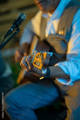 Close-up of a guitar being played, highlighting hands on strings and fretboard. Captures musical expression, creativity, and live performance atmosphere. Ideal for music, art, and entertainment themes