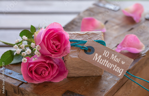 Mother's Day - Cute little gift package with pink roses and German text for 10. May Mother's Day on old wooden box