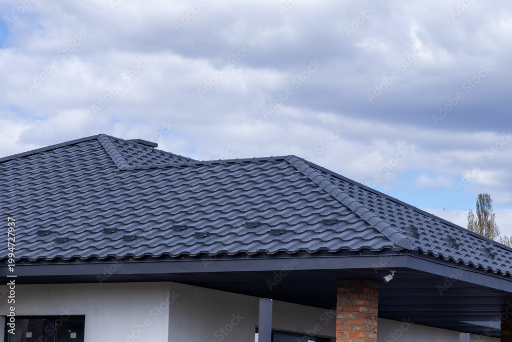 Fototapeta premium Roof Installation in a Residential Area on a Cloudy Day With a Modern Design and Unique Tiles