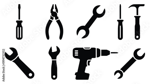 Silhouette icons of various tools including screwdrivers wrenches pliers and a drill on white background for diy and repair concepts