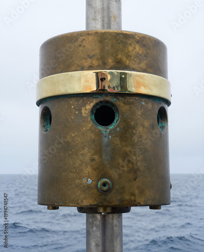 A close up of a metal object with two holes in it.. Multibeam sonar transducer close up.
