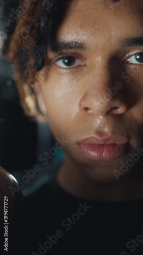 Sweat on face of exhausted sportsman after intense workout or match, closeup portrait. Motivation and will to win, tired junior athlete breathing hard and resting after marathon or sprint, box fighter