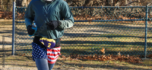 Runner Wearing American Flag Shorts Going for a Run in Park