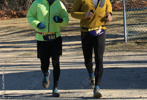 Two Runners Participating in a Local Race in a Park Setting