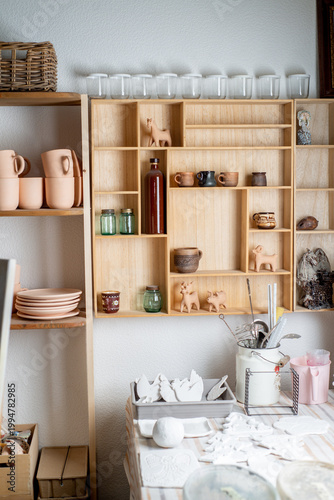 Interior pottery studio with a shelf of finished products