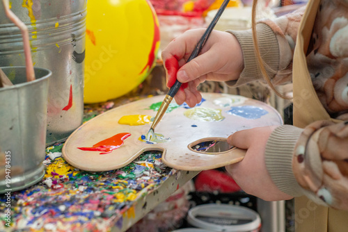 Palette with applied paint in your hands