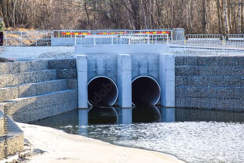 Double concrete culvert pipes with gabion retaining walls on construction site