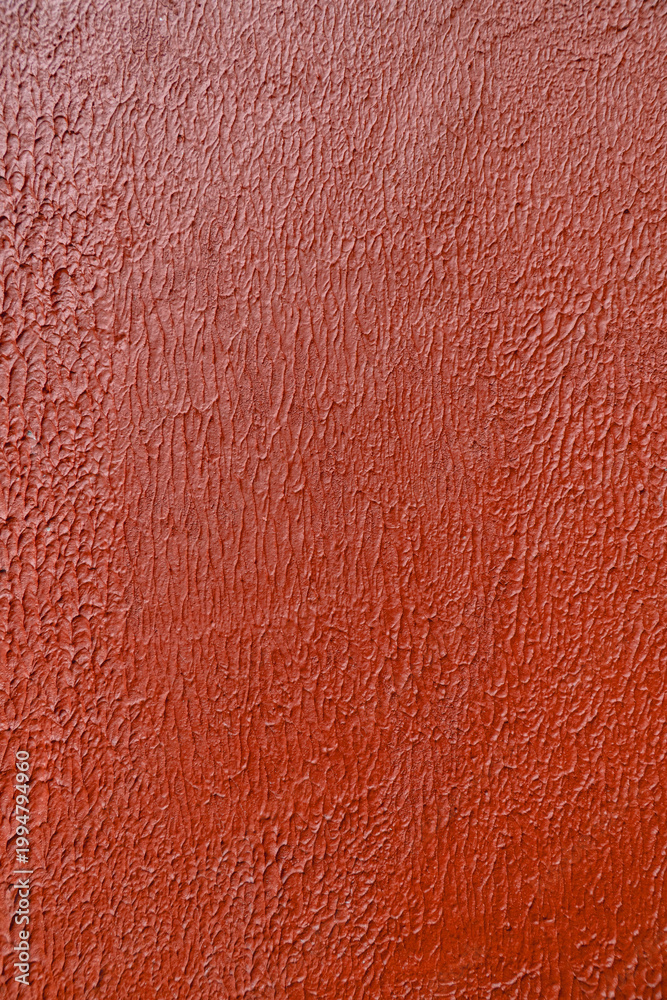 Fototapeta premium Red textured wall background with rough surface and subtle pattern, abstract backdrop ideal for copy space, design, and bold visual concepts