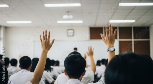 Students raising hands to answer questions in a classroom