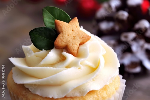 Fresh Cupcake With White Frosting and Star Cookie on Top With Green Leaves in...