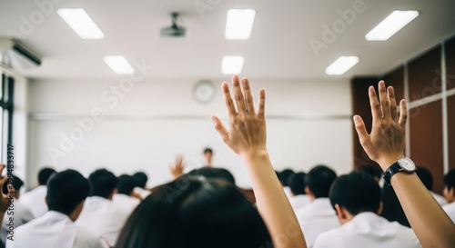 Students raising hands in classroom, diverse group of learners participating in lecture, academic education and active learning environment