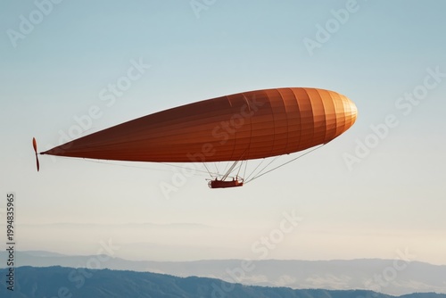 Flying Orange Airship Over Mountains in Daylight With Clear Sky