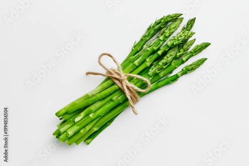 Fresh Asparagus Tied With Twine on a White Surface for Cooking or Preparing M...