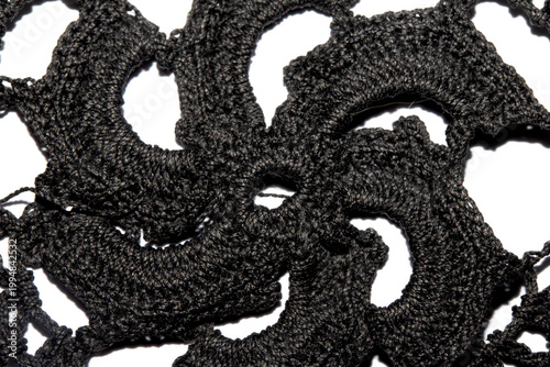 Close up of vintage black gothic lace fabric white on black background embroidery