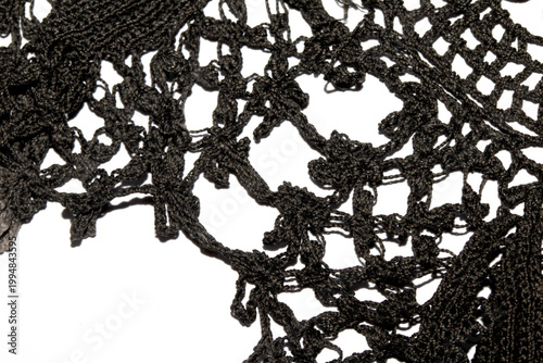 Close up of vintage black gothic lace fabric white on black background embroidery