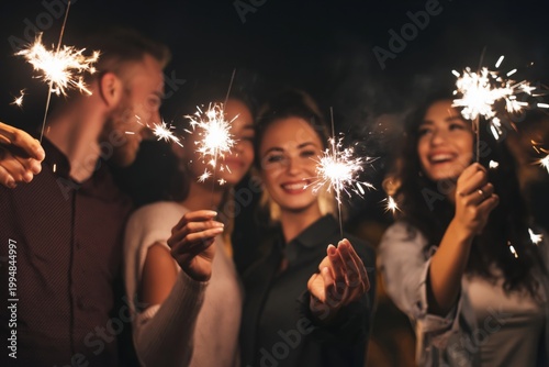 Friends Celebrate With Sparklers at a Night Gathering During a Festive Occasion