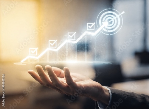 A business professional holds a glowing holographic growth chart with checkmark icons leading to a target symbol, representing corporate success, strategic planning, and achievement in modern office.