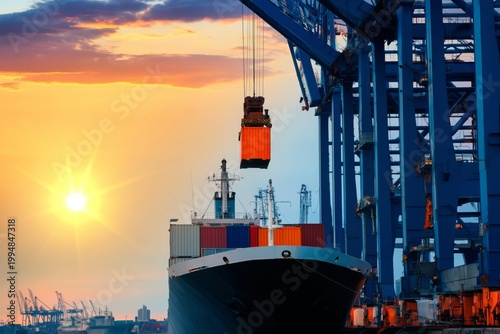 Cargo Being Loaded Onto a Ship at Sunset in a Busy Port