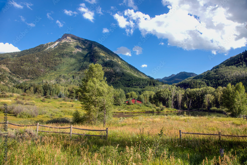 Fototapeta premium Remote mountain meadow ecosystem with freshwater pond