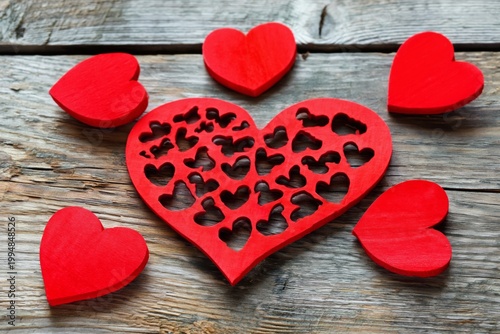 Red Heart Cushion With Smaller Hearts on Wooden Table for Decoration