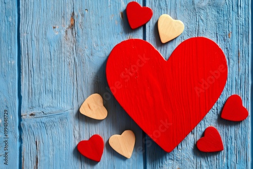 Red Heart Decoration Placed on Blue Wooden Background With Smaller Hearts Around