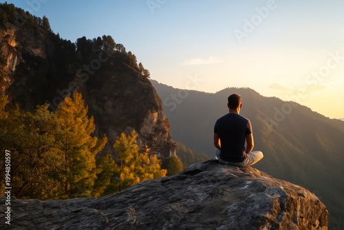 Man Sits on a Rock Overlooking Mountains During Sunset in Nature