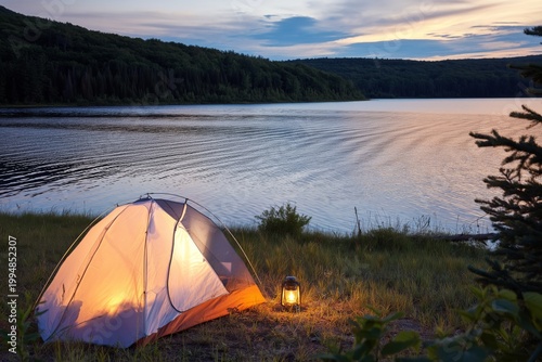 Camping by the Lake With Tent and Lantern During Sunset in a Forested Area