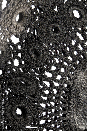 Close up of vintage black gothic lace fabric white on black background embroidery