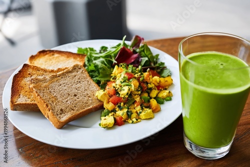 Healthy Breakfast With Spinach, Eggs, Toast, and Green Smoothie Served on a W...