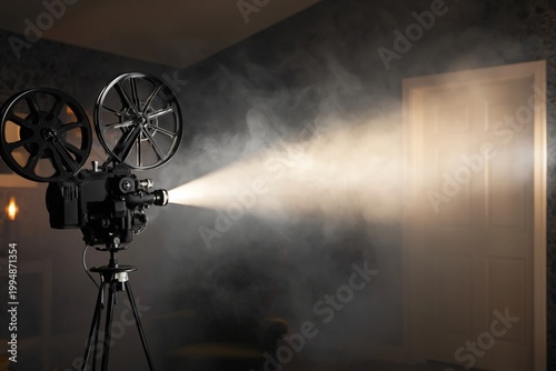 Vintage Film Projector Shines Light Through Smoke in a Dark Room at Night