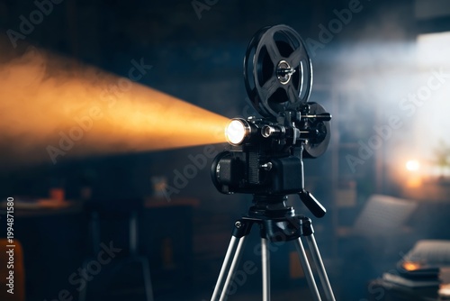 Old Film Projector Shines Light in a Room With Dark Walls and Soft Light Duri...
