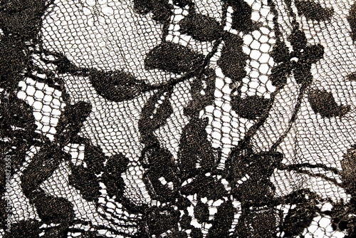 Close up of vintage black gothic lace fabric white on black background embroidery