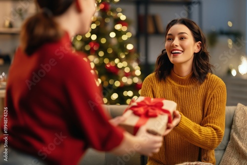 Woman Smiles While Receiving a Gift During a Holiday Gathering With Decoratio...