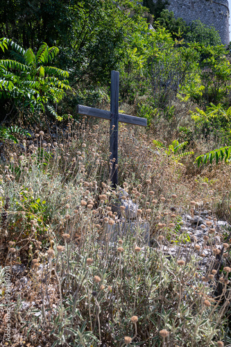 One of Dubrovnik's Stations of the Cross. Mount Srd hiking trail. Wooden cross on the rocks.  
