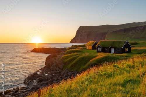 Sunset Over Grassy Hills and Houses Near the Coast With Distant Cliffs in the...