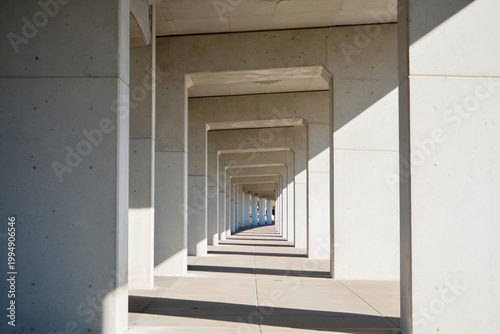 Concrete pillars creating a repeating geometric tunnel effect