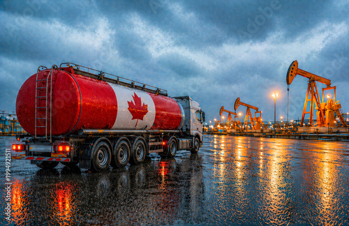 Oil tanker truck with Canadian flag in Alberta oil field