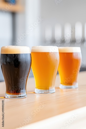 Craft beer flight offering a variety of tastes and vibrant colors, displaying different types of cold ale and stout in glasses at a modern brewery or bar taproom