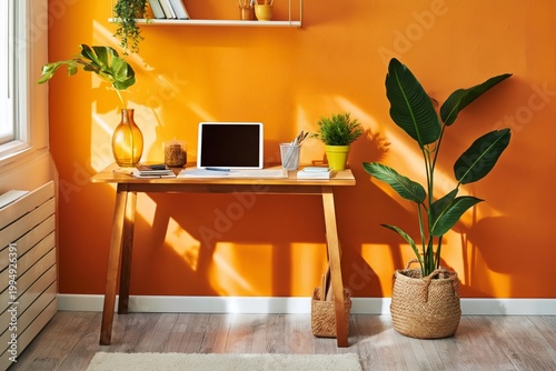 Bright Workspace With Plants and a Computer in a Room With Orange Walls and S...